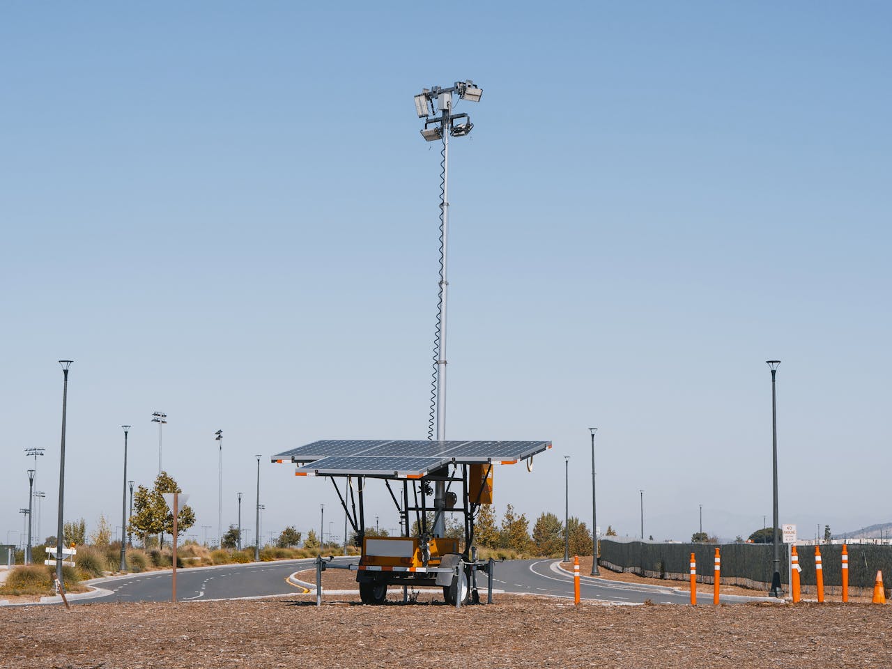 our-story Solar powered streetlights under a clear blue sky, emphasizing renewable energy.